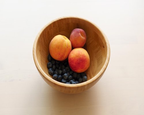Healthy breakfast bowl with fruits and nuts on table